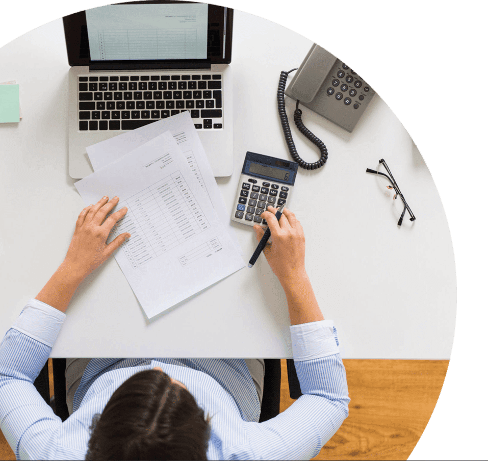 Top view of a business man working on computer and calculator